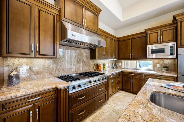 a view of a dining room with furniture and a chandelier