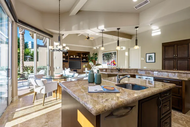 a living room with lots of furniture and view of kitchen