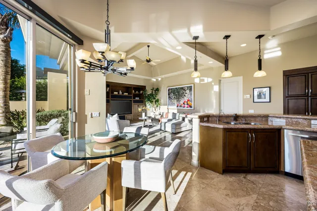 a view of a patio with couches table and chairs and potted plants
