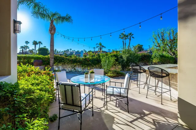 a living room with furniture wooden floor and a large window