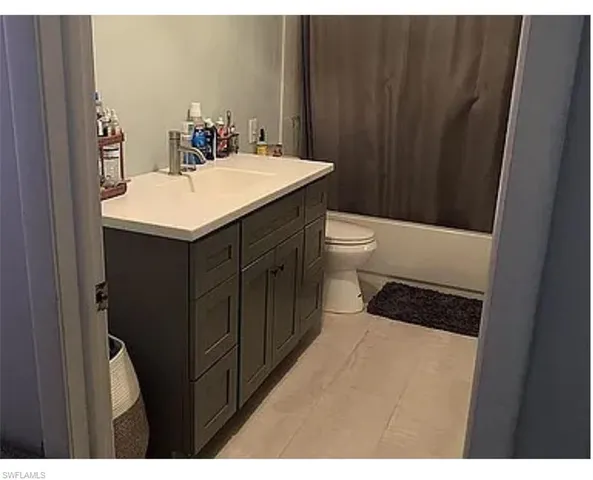 a bathroom with a sink a toilet and mirror