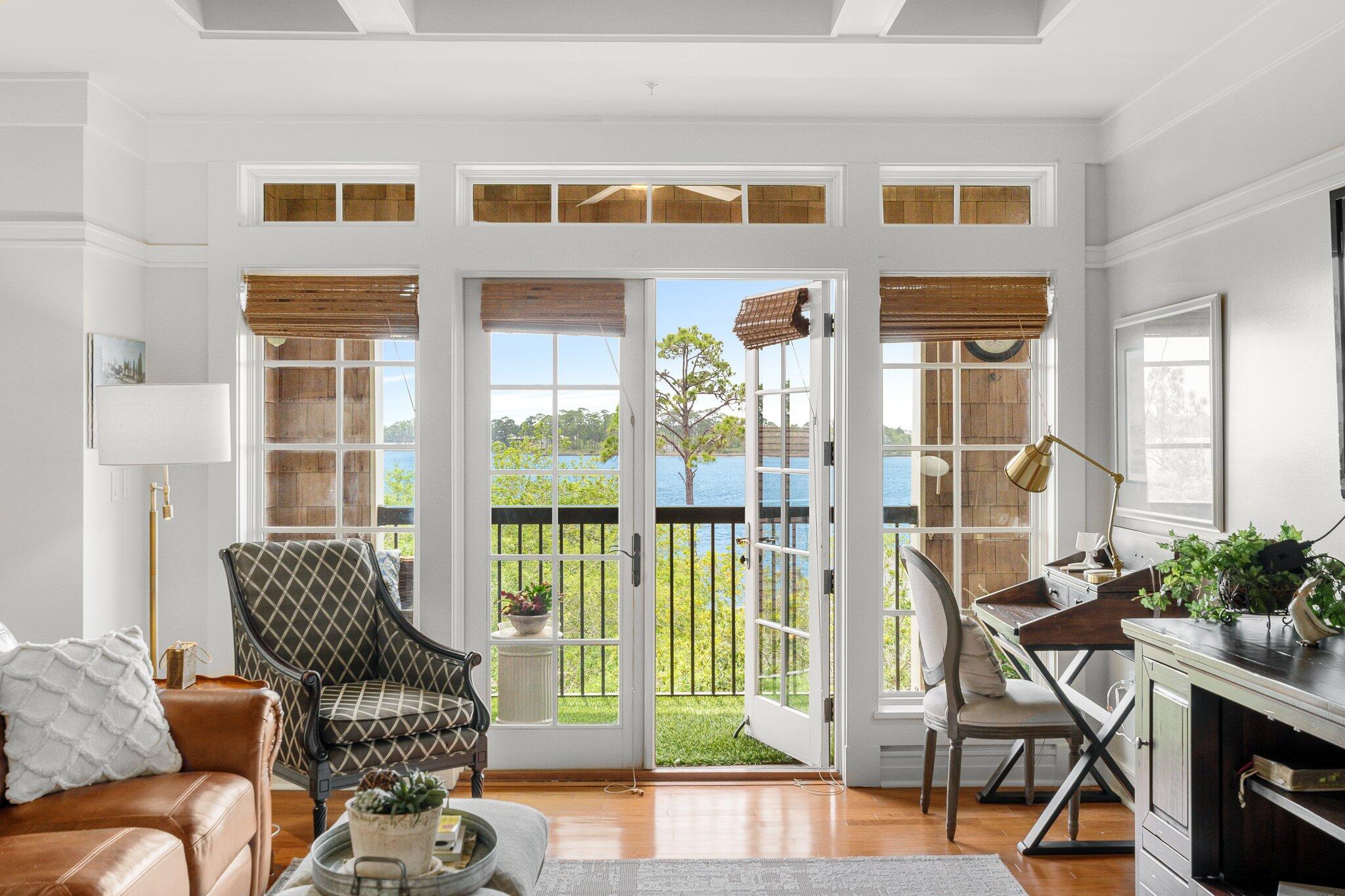 1102 Prospect Promenade, Unit 202 Panama City Beach, FL 32413 - Photo 14 of 35 a living room with furniture and a floor to ceiling window