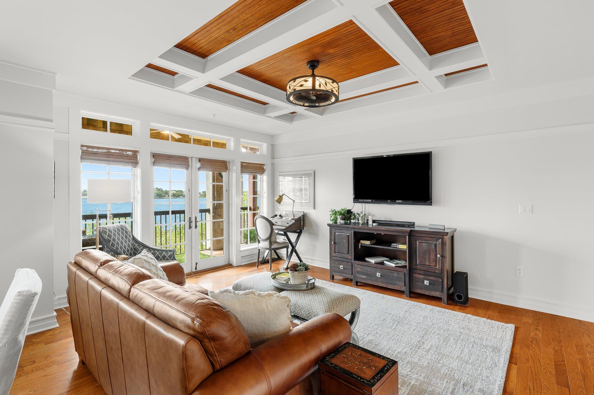 1102 Prospect Promenade, Unit 202 Panama City Beach, FL 32413 - Photo 15 of 35 a living room with furniture and a flat screen tv