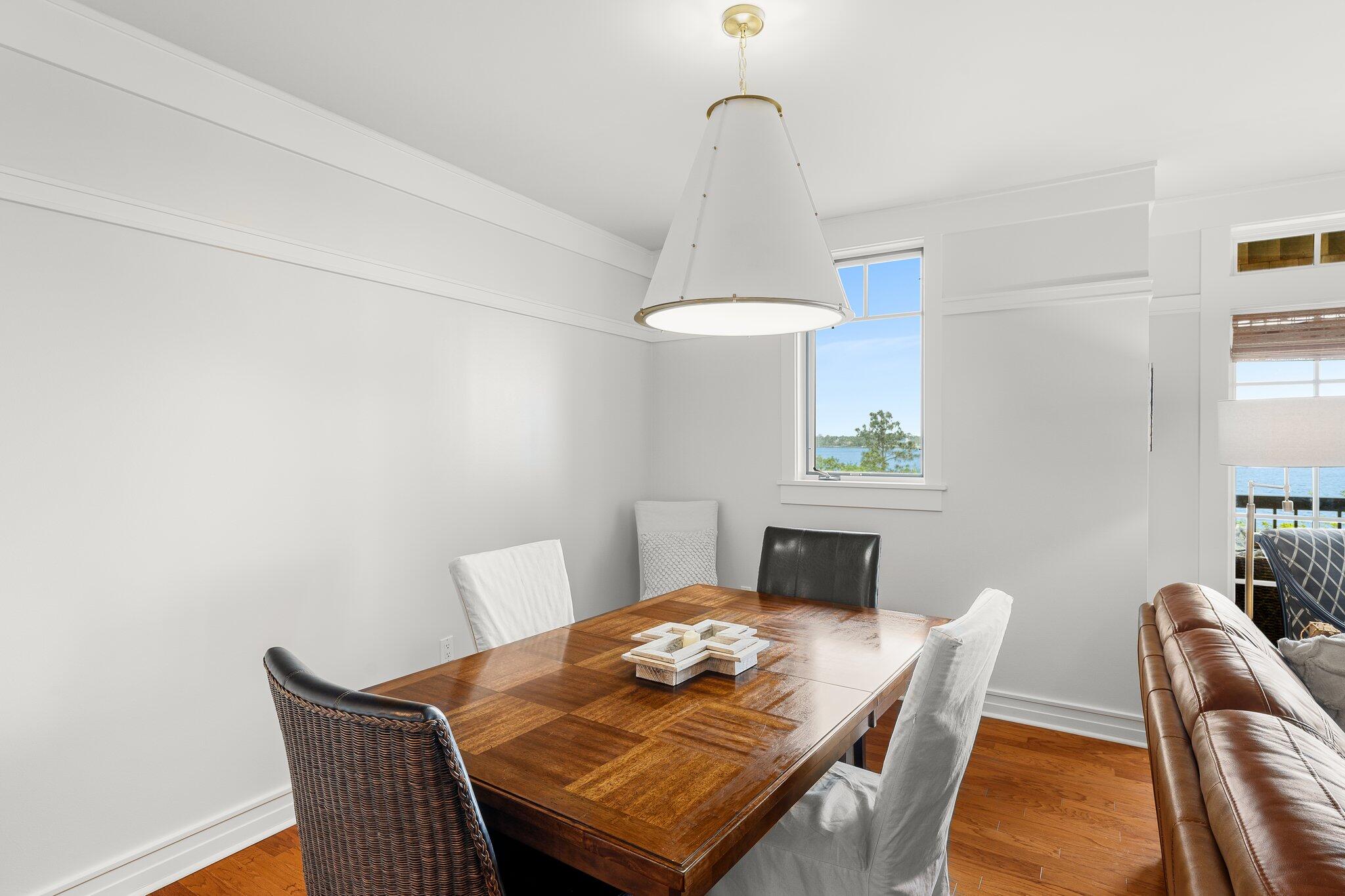 1102 Prospect Promenade, Unit 202 Panama City Beach, FL 32413 - Photo 16 of 35 a view of a dining room with furniture
