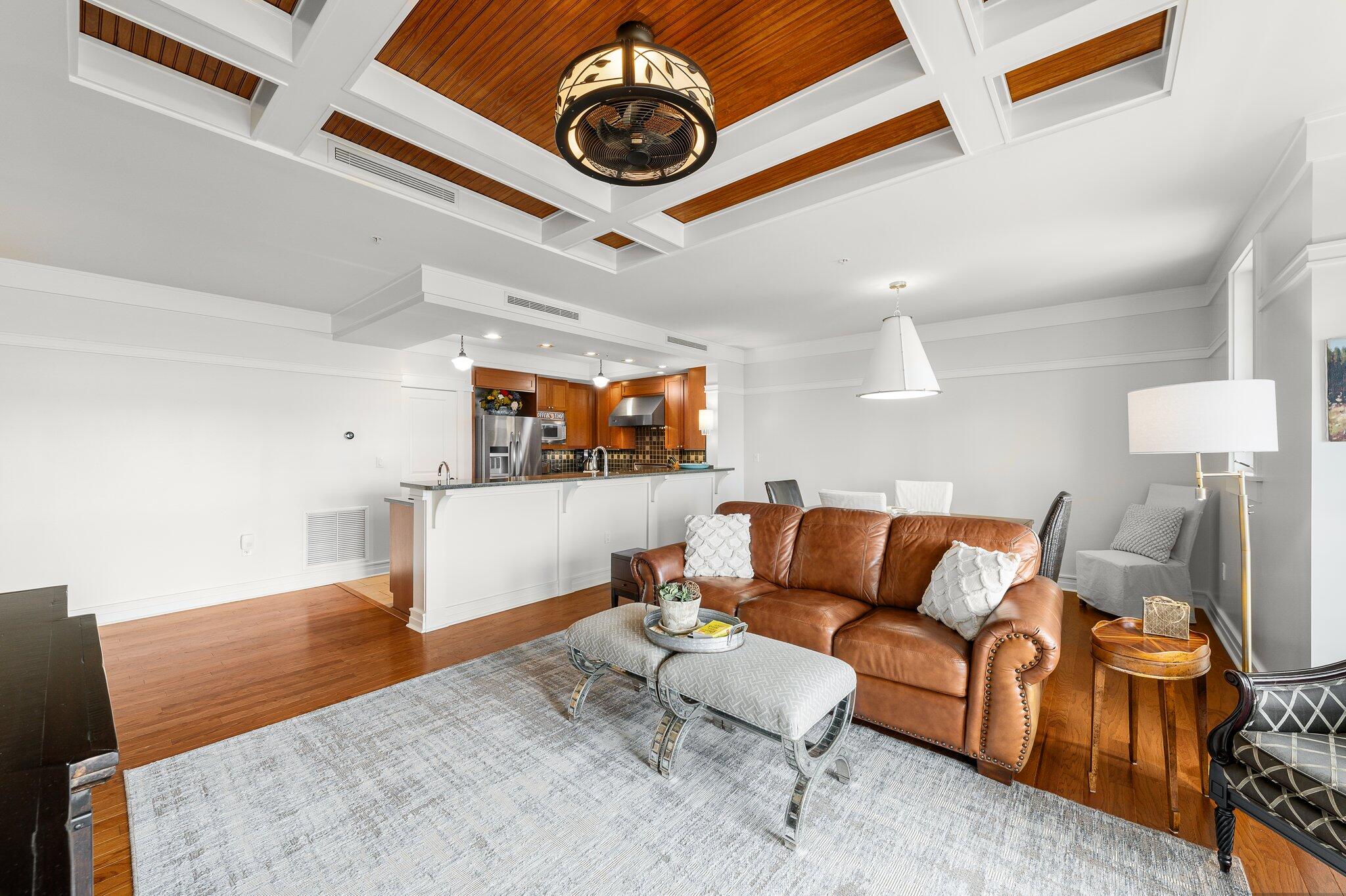 1102 Prospect Promenade, Unit 202 Panama City Beach, FL 32413 - Photo 17 of 35 a living room with furniture and a clock