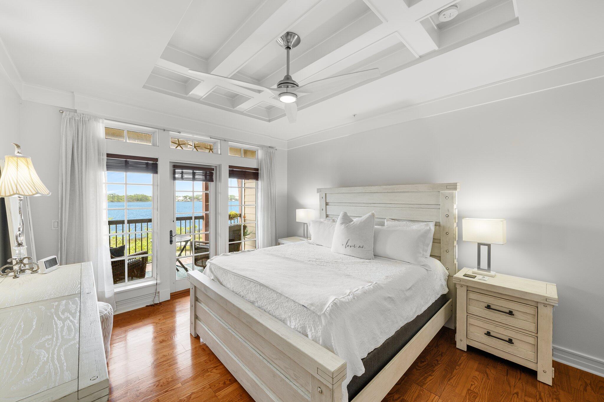 1102 Prospect Promenade, Unit 202 Panama City Beach, FL 32413 - Photo 19 of 35 a bedroom with a bed and a large window