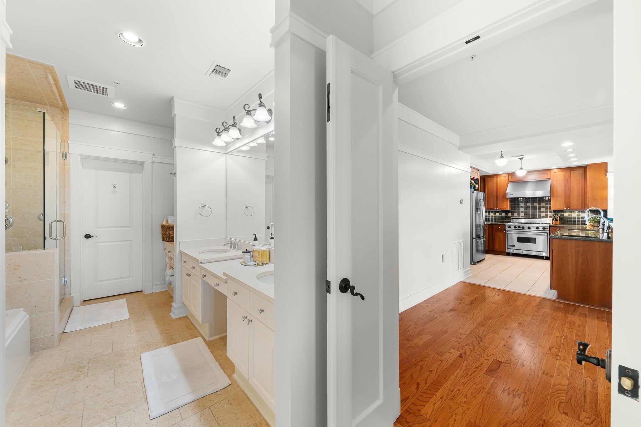 1102 Prospect Promenade, Unit 202 Panama City Beach, FL 32413 - Photo 21 of 35 a bathroom with a sink and mirror with shower