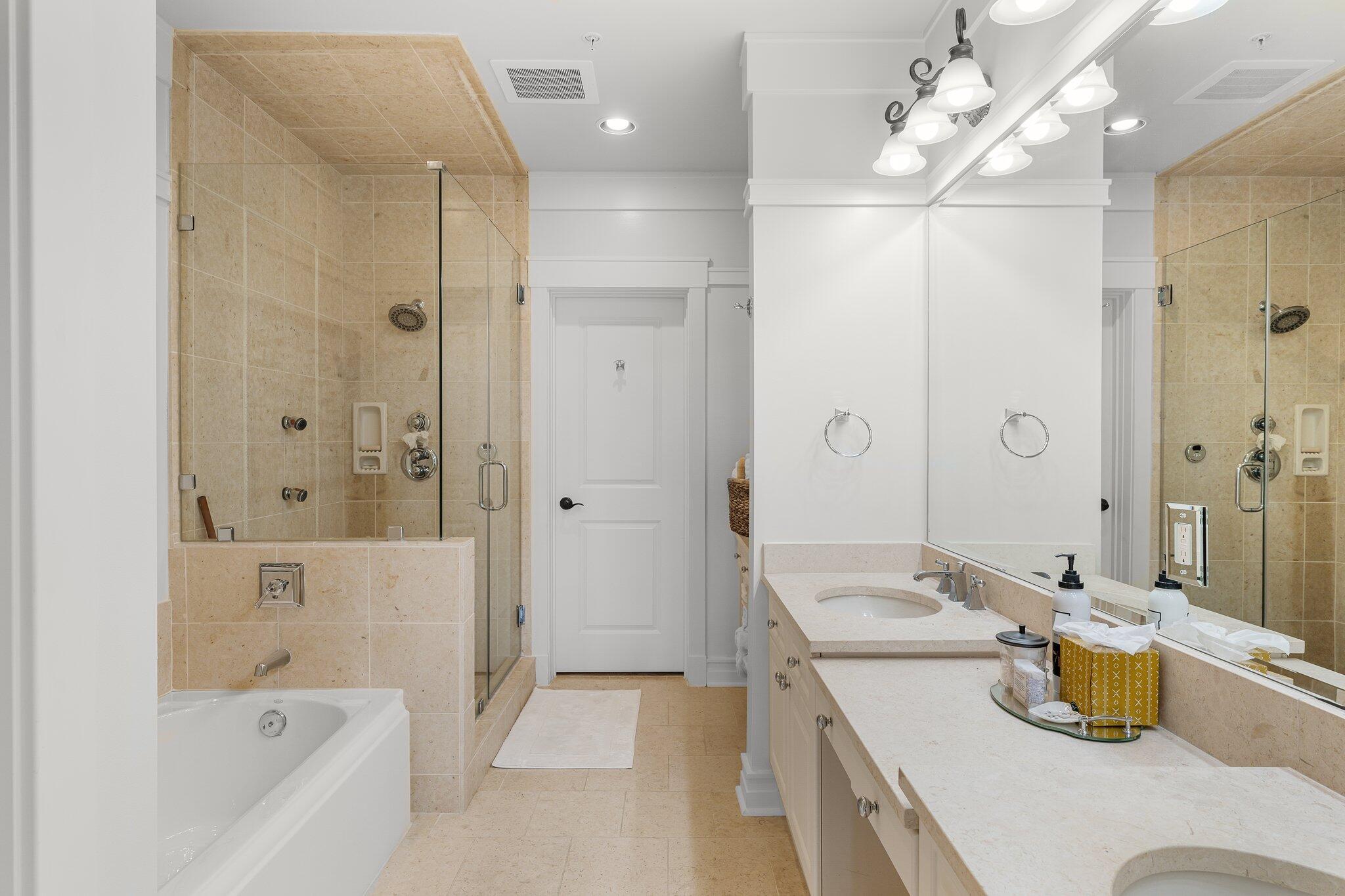 1102 Prospect Promenade, Unit 202 Panama City Beach, FL 32413 - Photo 22 of 35 a bathroom with a tub sink and mirror