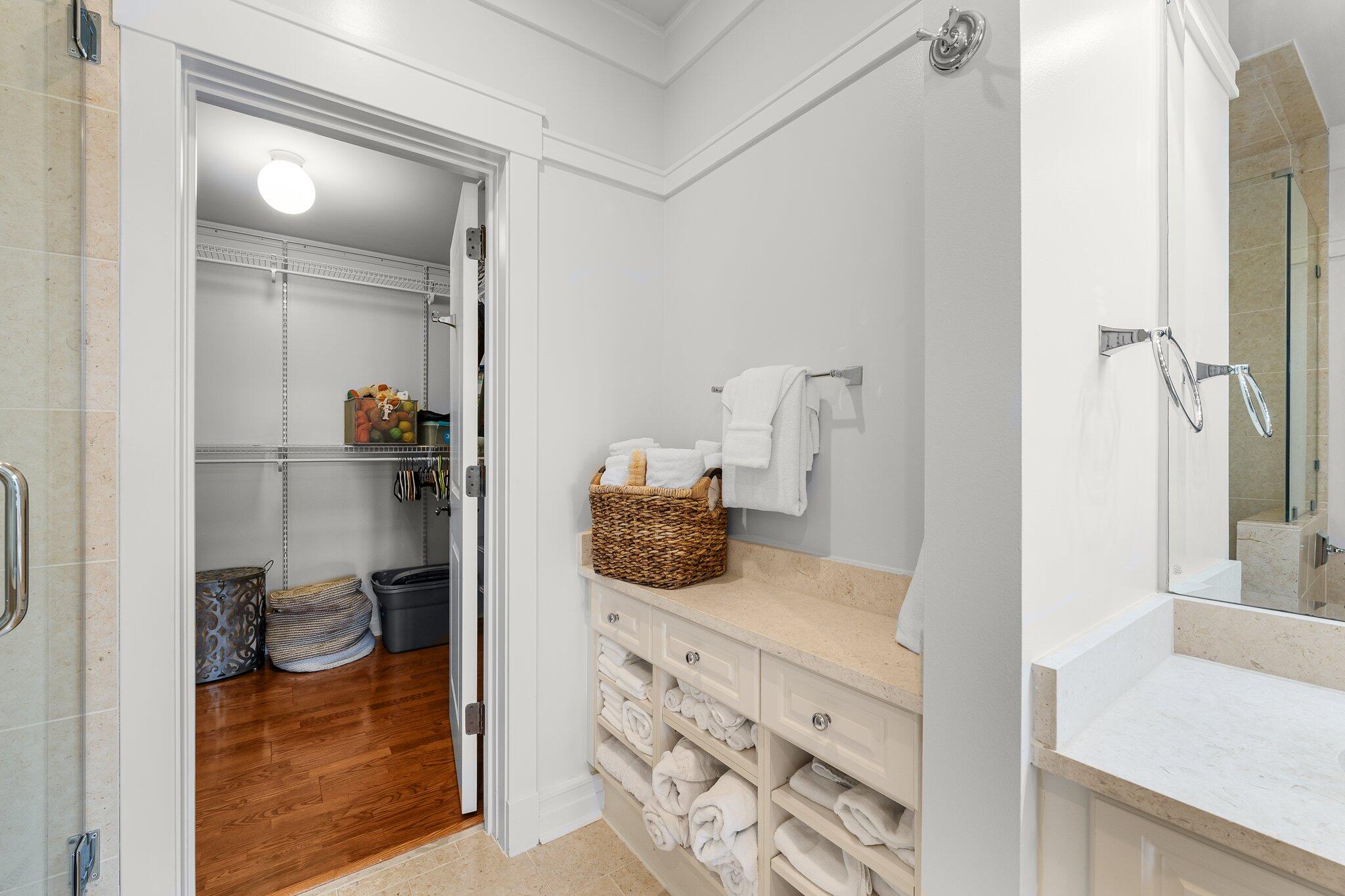 1102 Prospect Promenade, Unit 202 Panama City Beach, FL 32413 - Photo 24 of 35 a en suite bathroom with a granite countertop sink and a mirror