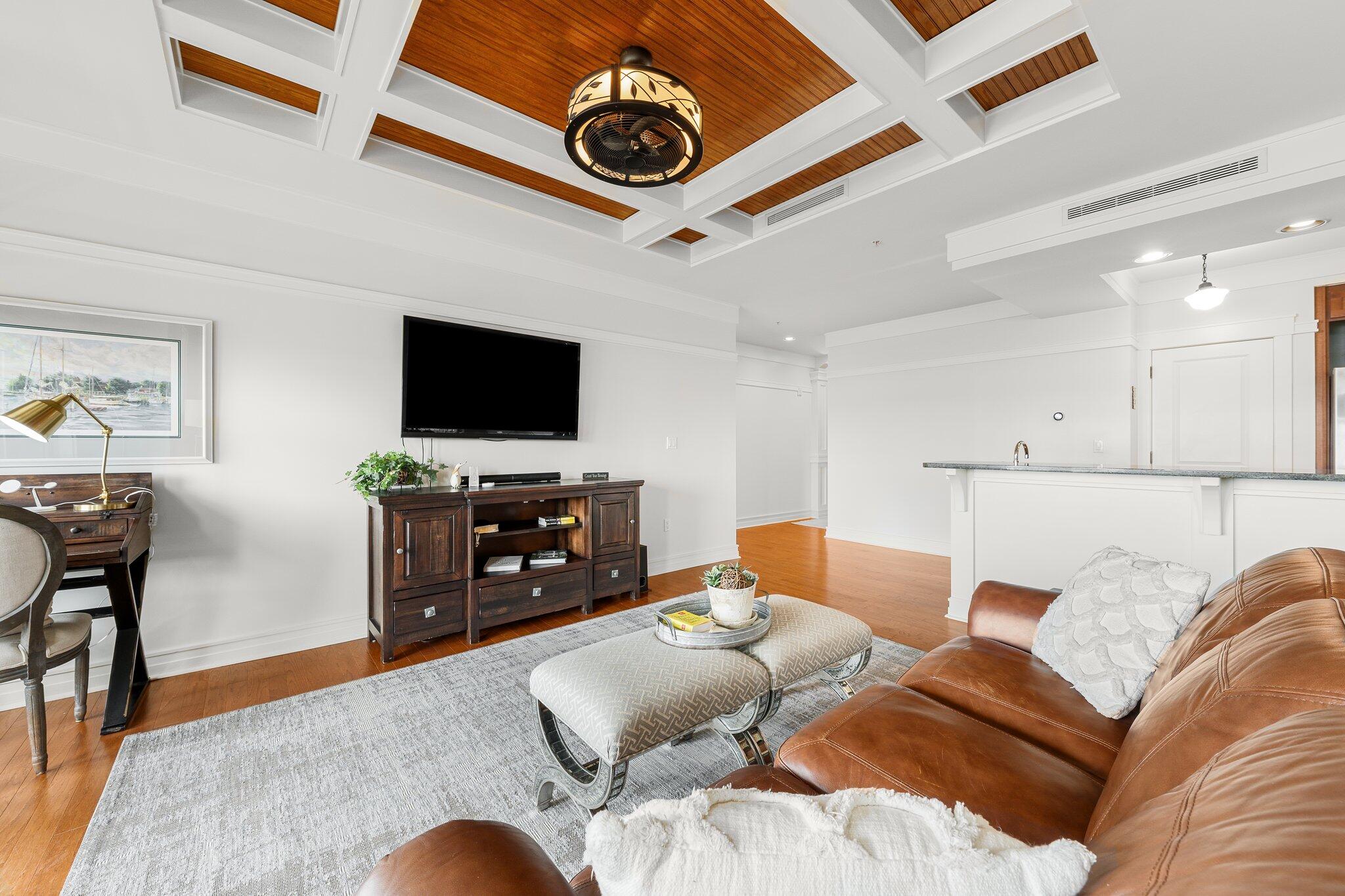 1102 Prospect Promenade, Unit 202 Panama City Beach, FL 32413 - Photo 30 of 35 a living room with furniture and a flat screen tv