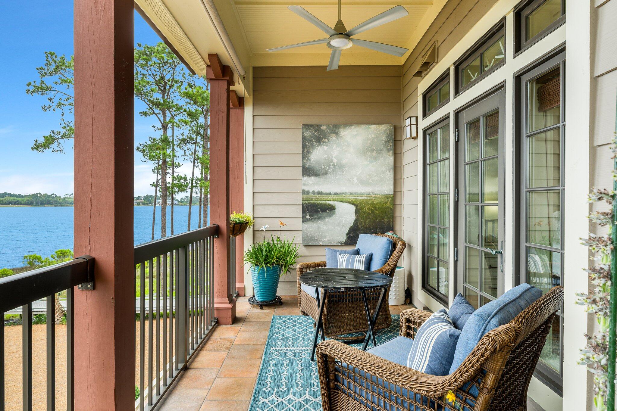 1102 Prospect Promenade, Unit 202 Panama City Beach, FL 32413 - Photo 32 of 35 a balcony with furniture and a potted plant