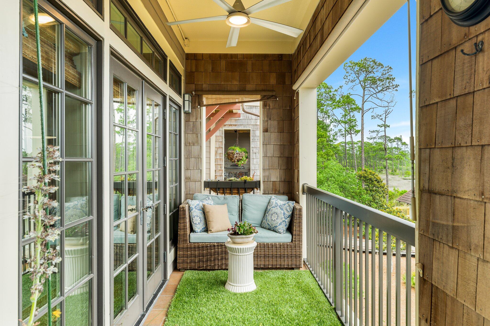 1102 Prospect Promenade, Unit 202 Panama City Beach, FL 32413 - Photo 34 of 35 a view of a porch with chairs and backyard