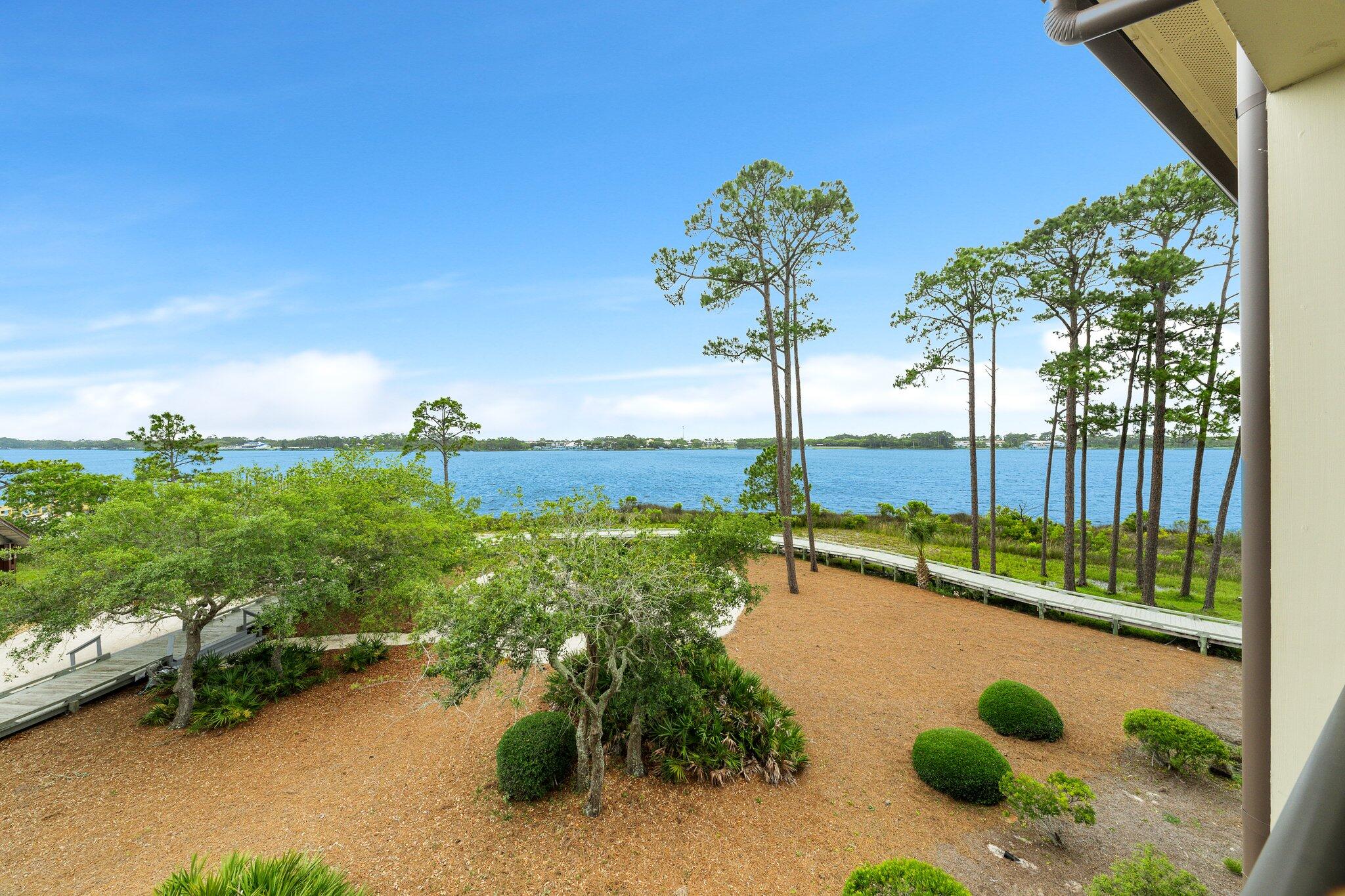 1102 Prospect Promenade, Unit 202 Panama City Beach, FL 32413 - Photo 35 of 35 a view of a lake with a floor to ceiling window next to a road