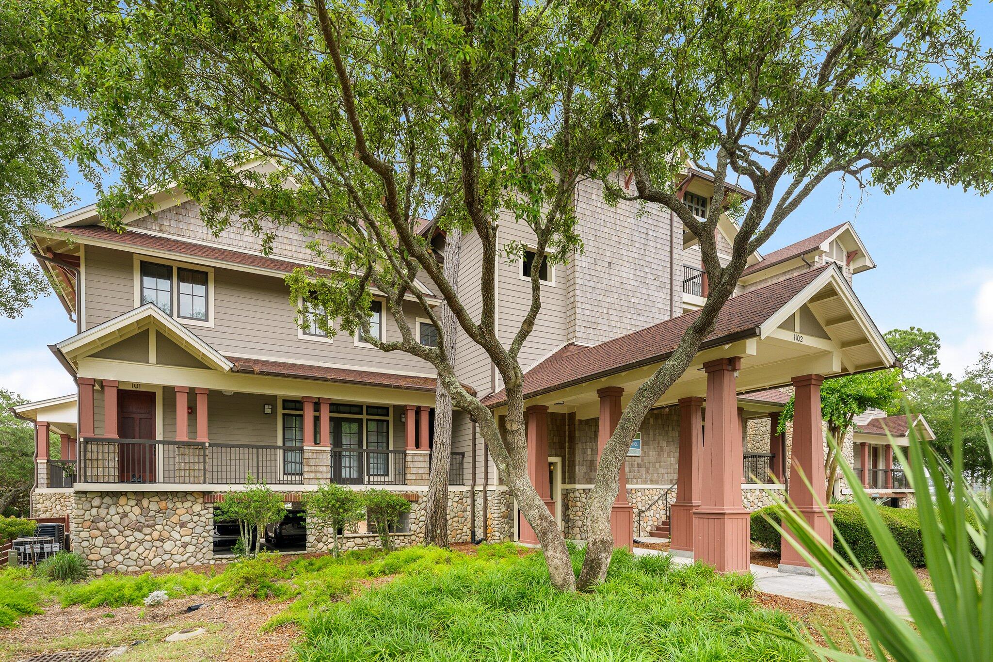 1102 Prospect Promenade, Unit 202 Panama City Beach, FL 32413 - Photo 5 of 35 a front view of a house with a yard