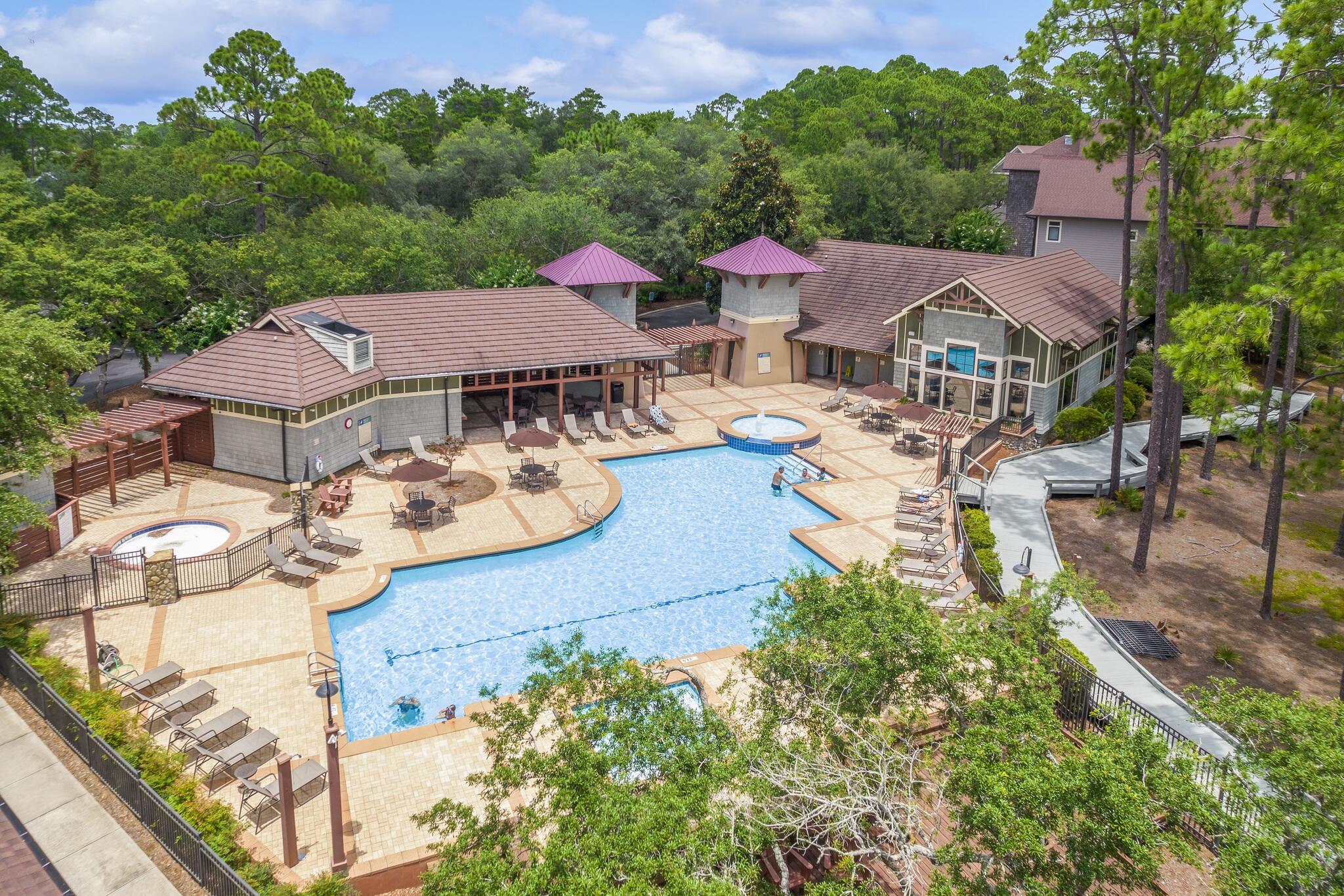 1102 Prospect Promenade, Unit 202 Panama City Beach, FL 32413 - Photo 6 of 35 an aerial view of residential houses with outdoor space and trees