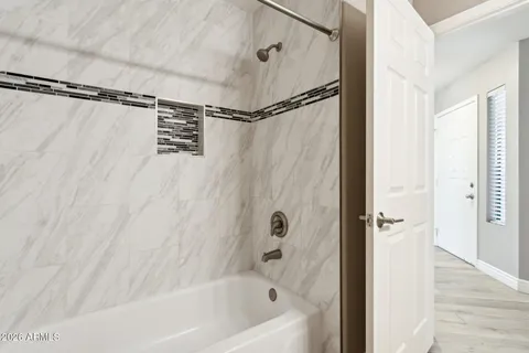 a bathroom with a bathtub and a shower
