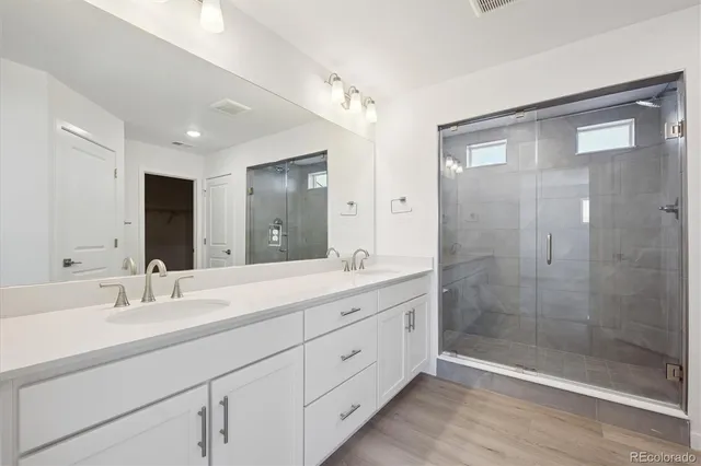 a bathroom with double sink and shower