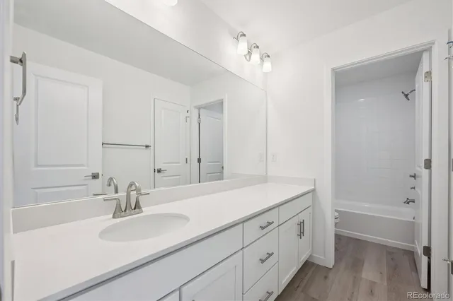 a bathroom with a sink double vanity granite tub and shower