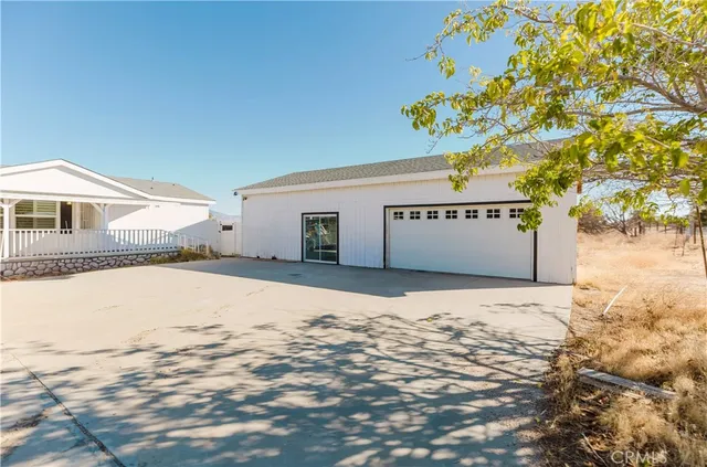 a bathroom with a granite countertop sink double vanity and a mirror