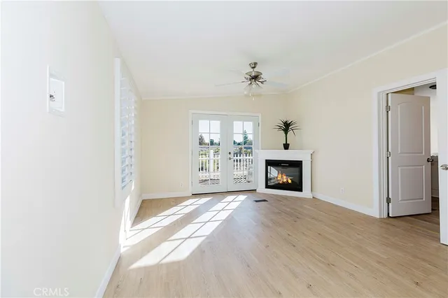 a living room with furniture and a dining table with kitchen view