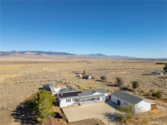 a view of a livingroom with a fireplace and window