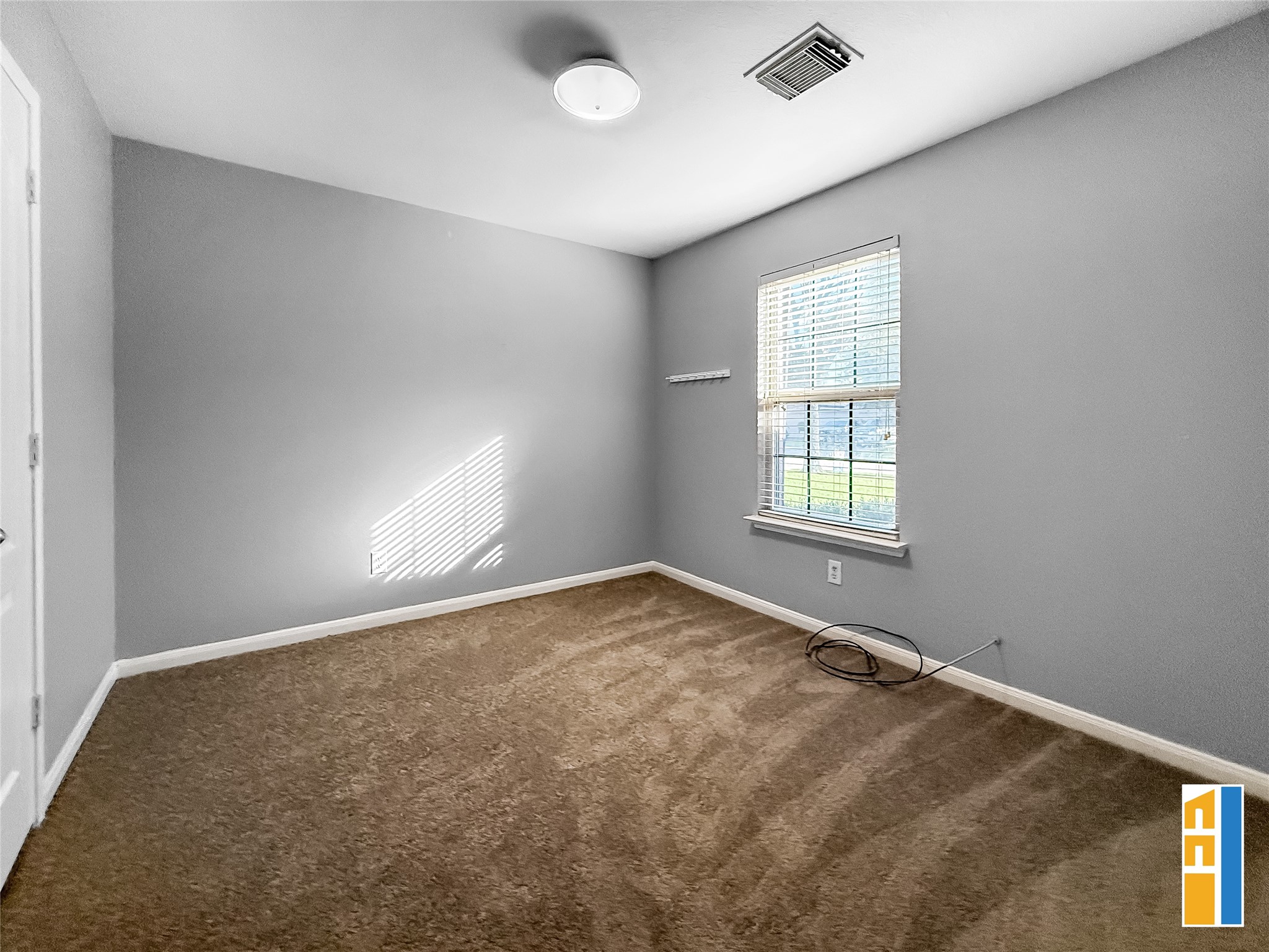 29566 North Legends Bend Drive Spring, TX 77386 - Photo 19 of 21 Discover a cozy secondary bedroom with soft carpeting, ample natural light, and a soothing neutral palette—perfect for relaxation or a versatile home office.