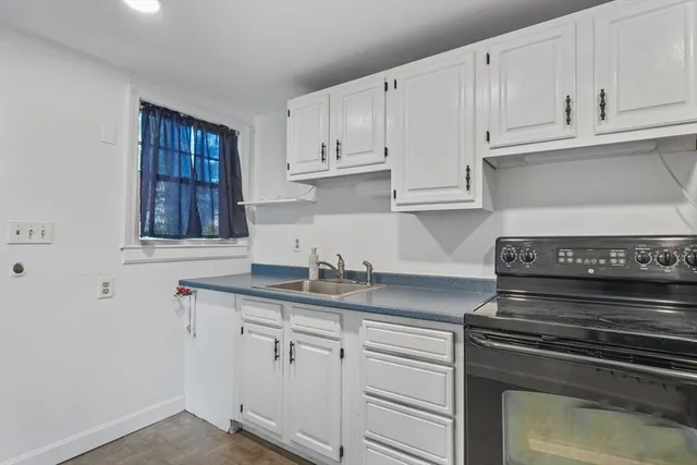 a kitchen with a sink and cabinets