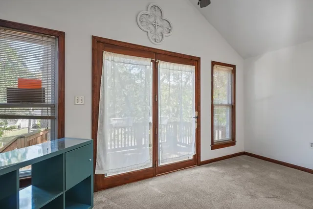 an empty room with windows cabinet and windows