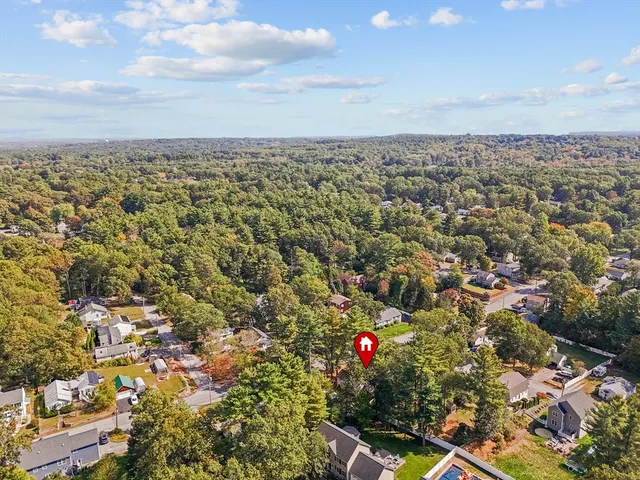 an aerial view of town with residential buildings and mountain view in back