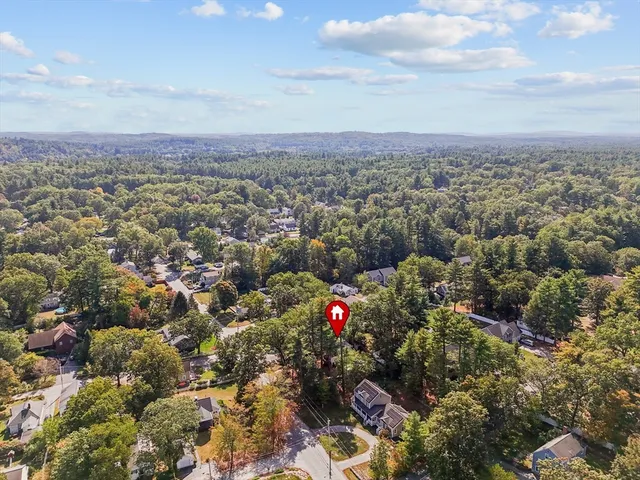 an aerial view of a house with a yard