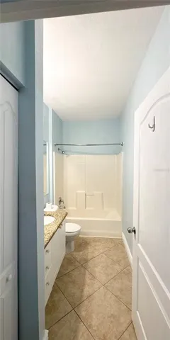 a view of an empty room with window and stairs