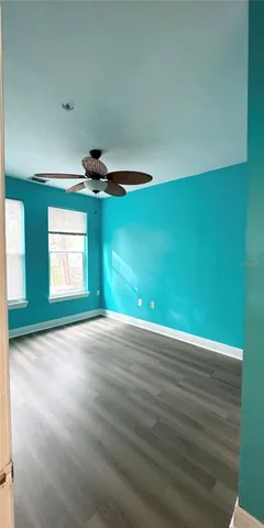 a view of an empty room with a fan