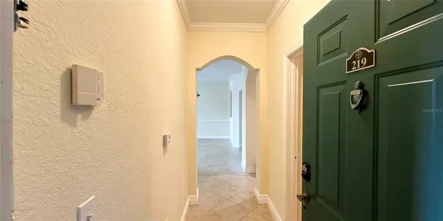 a view of a hallway with wooden floor and a cabinet
