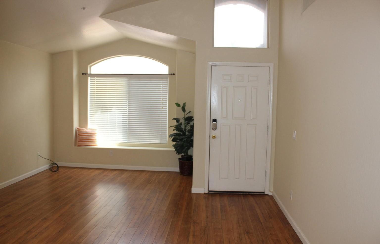 9456 East Pine Valley Road Scottsdale, AZ 85260 - Photo 13 of 18 an empty room with wooden floor and windows