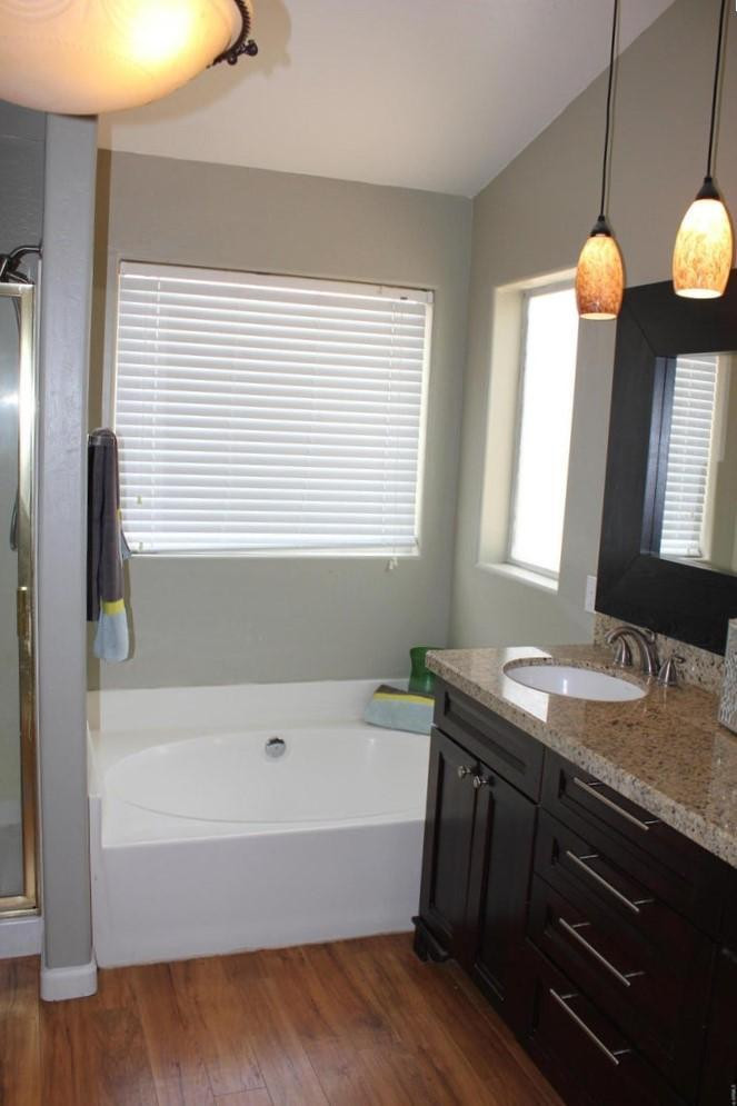 9456 East Pine Valley Road Scottsdale, AZ 85260 - Photo 16 of 18 a bathroom with a granite countertop sink and a bathtub