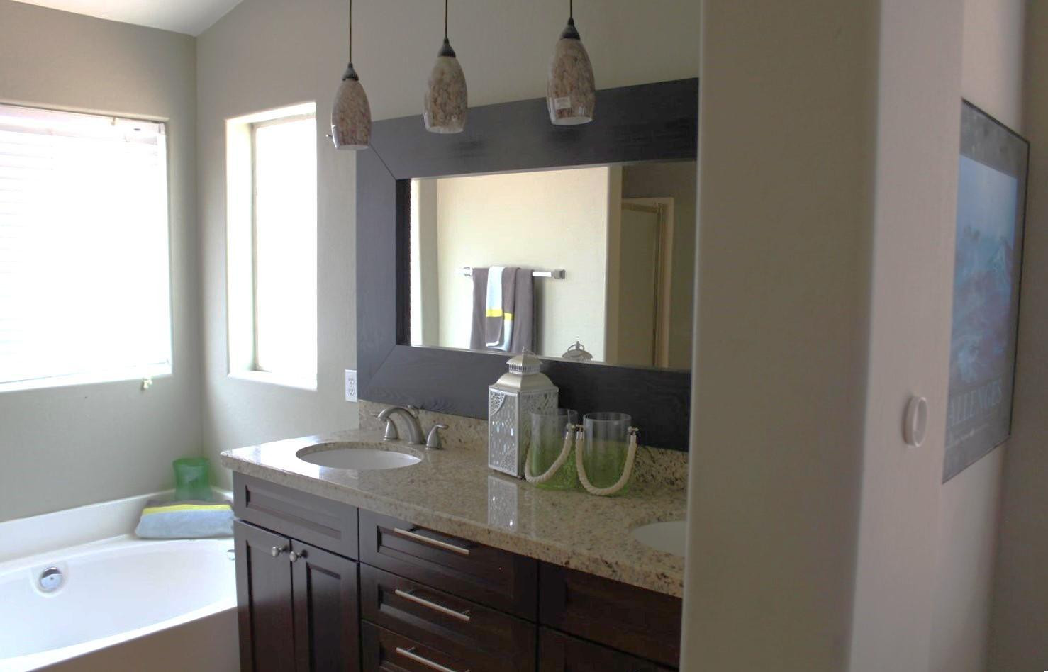 9456 East Pine Valley Road Scottsdale, AZ 85260 - Photo 17 of 18 a bathroom with a granite countertop sink a mirror and shower
