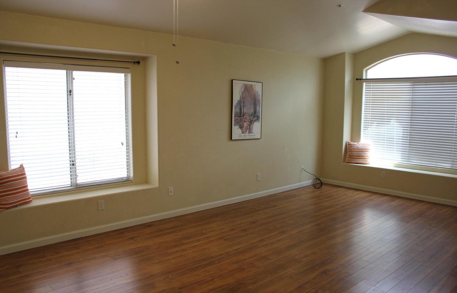 9456 East Pine Valley Road Scottsdale, AZ 85260 - Photo 2 of 18 a view of an empty room with wooden floor and a window