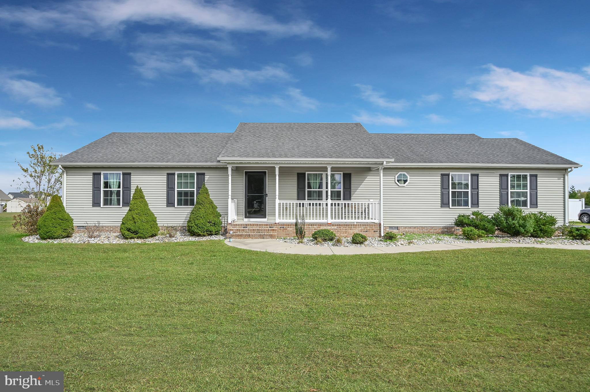 36809 Red Berry Road Delmar, DE 19940 - Photo 1 of 19 a view of a house with a big yard and potted plants