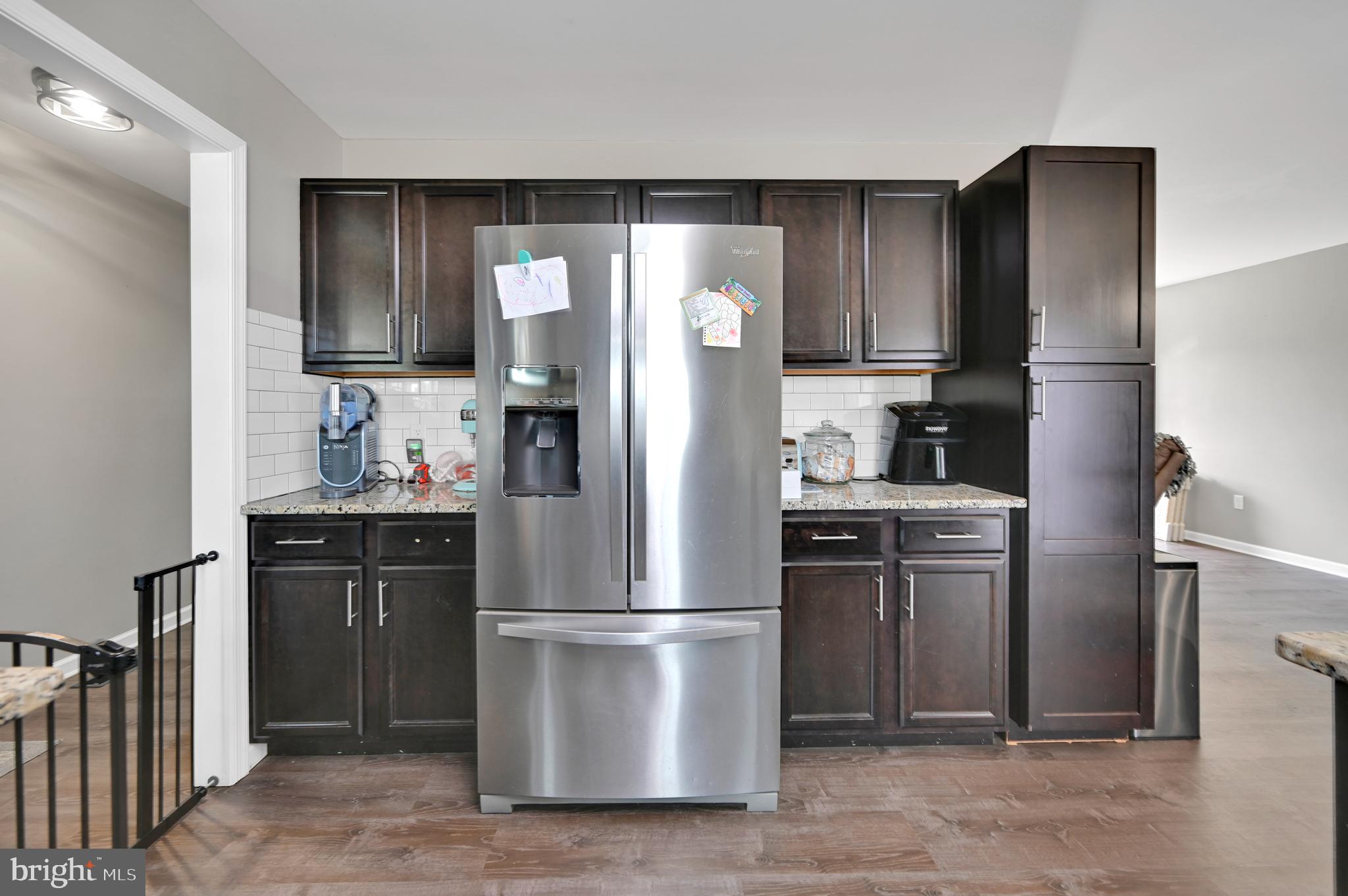 36809 Red Berry Road Delmar, DE 19940 - Photo 4 of 19 a kitchen with stainless steel appliances granite countertop a refrigerator and a sink