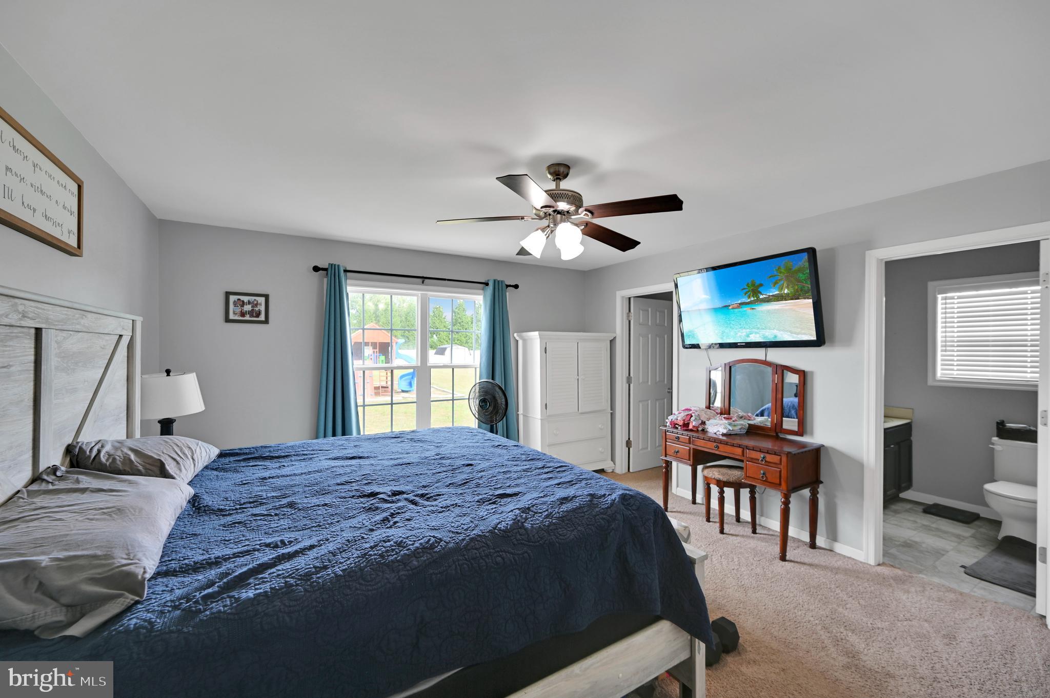 36809 Red Berry Road Delmar, DE 19940 - Photo 9 of 19 a bedroom with a bed and a chandelier