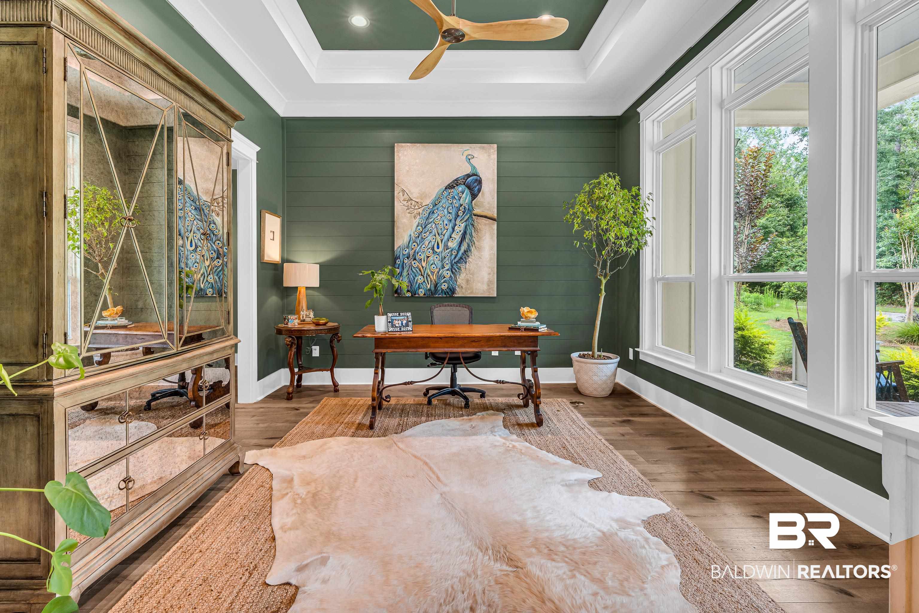 17541 Polo Ridge Boulevard Fairhope, AL 36532 - Photo 4 of 19 Hardwood-style flooring throughout this room, featuring a tray ceiling with a ceiling fan, recessed lighting, and large picture windows
