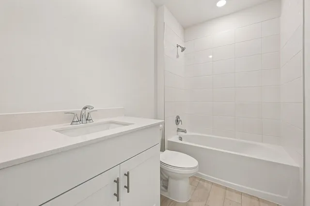 a bathroom with a sink a toilet and bathtub