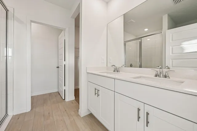 a bathroom with a double vanity sink and mirror