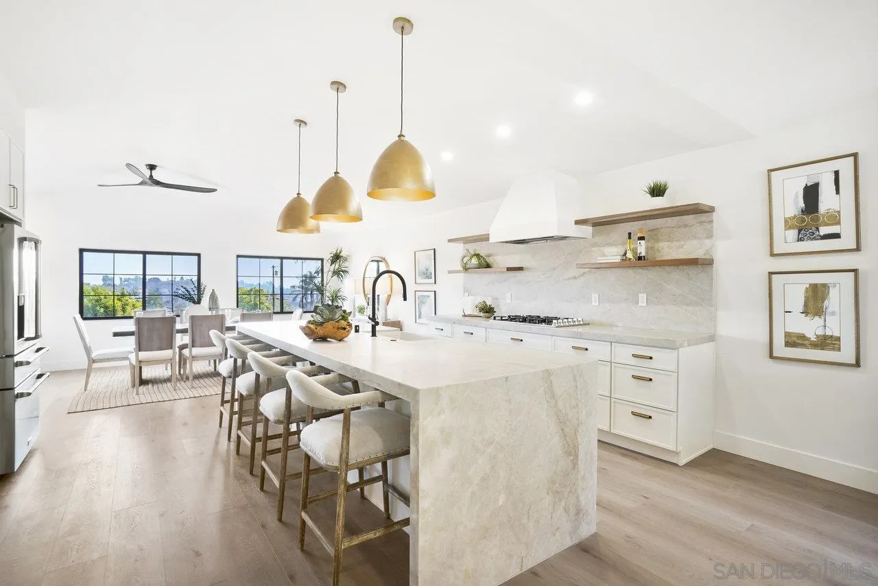 8843 Mariposa Street La Mesa, CA 91941 - Photo 11 of 60 a kitchen with a table chairs stove and wooden floor