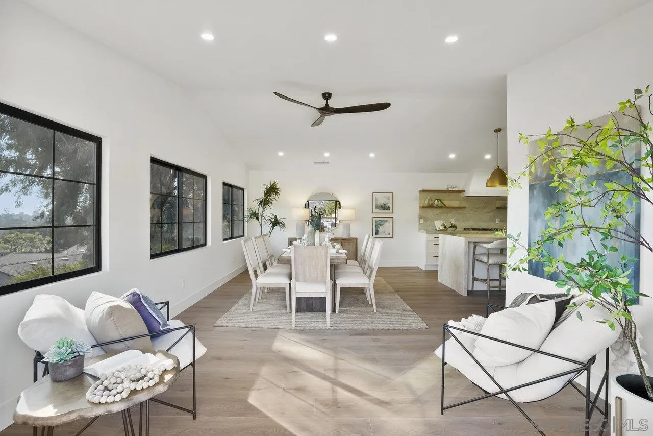 8843 Mariposa Street La Mesa, CA 91941 - Photo 16 of 60 a dining room with furniture a floor to ceiling window and potted plants