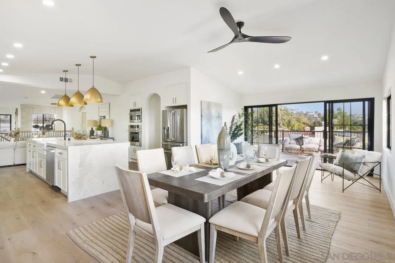 8843 Mariposa Street La Mesa, CA 91941 - Photo 21 of 60 a dining room with furniture a chandelier and wooden floor