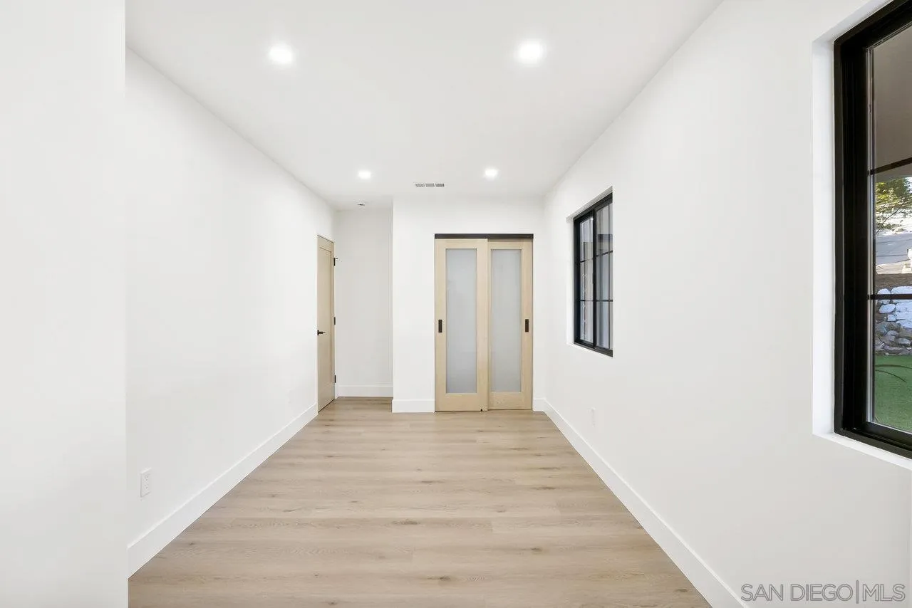 8843 Mariposa Street La Mesa, CA 91941 - Photo 26 of 60 a view of a hallway with wooden floor