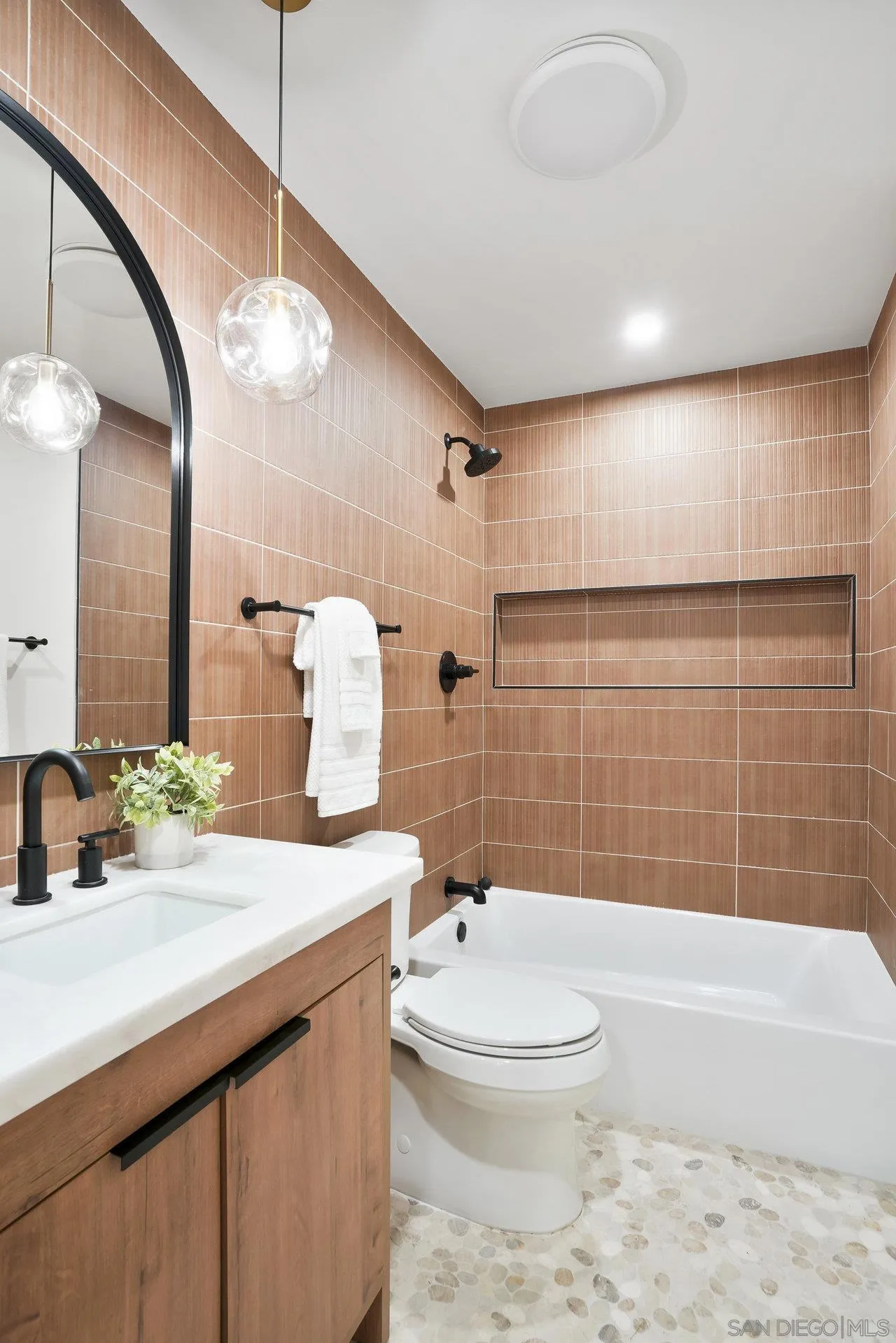 8843 Mariposa Street La Mesa, CA 91941 - Photo 29 of 60 a bathroom with a sink a toilet and shower