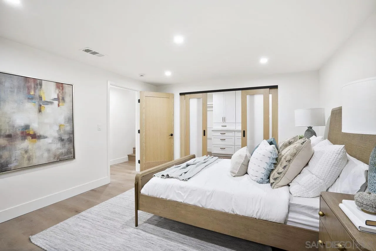 8843 Mariposa Street La Mesa, CA 91941 - Photo 34 of 60 a bedroom with a large bed and a painting on the wall