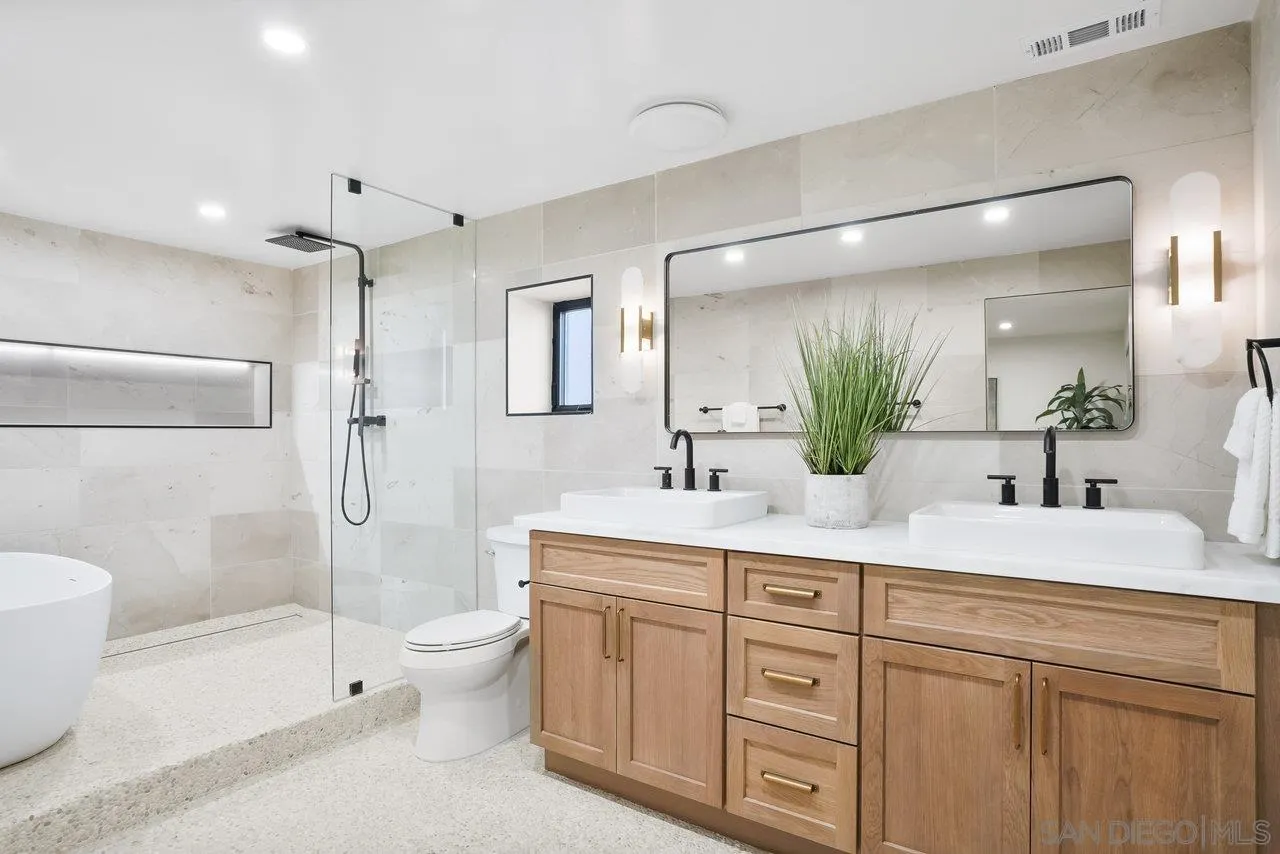 8843 Mariposa Street La Mesa, CA 91941 - Photo 36 of 60 a bathroom with a sink a toilet and shower